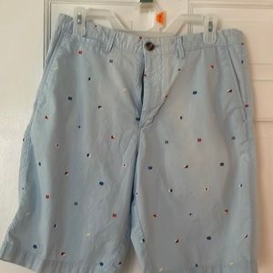 Men’s Merona light blue shorts with nautical flag embellishments.